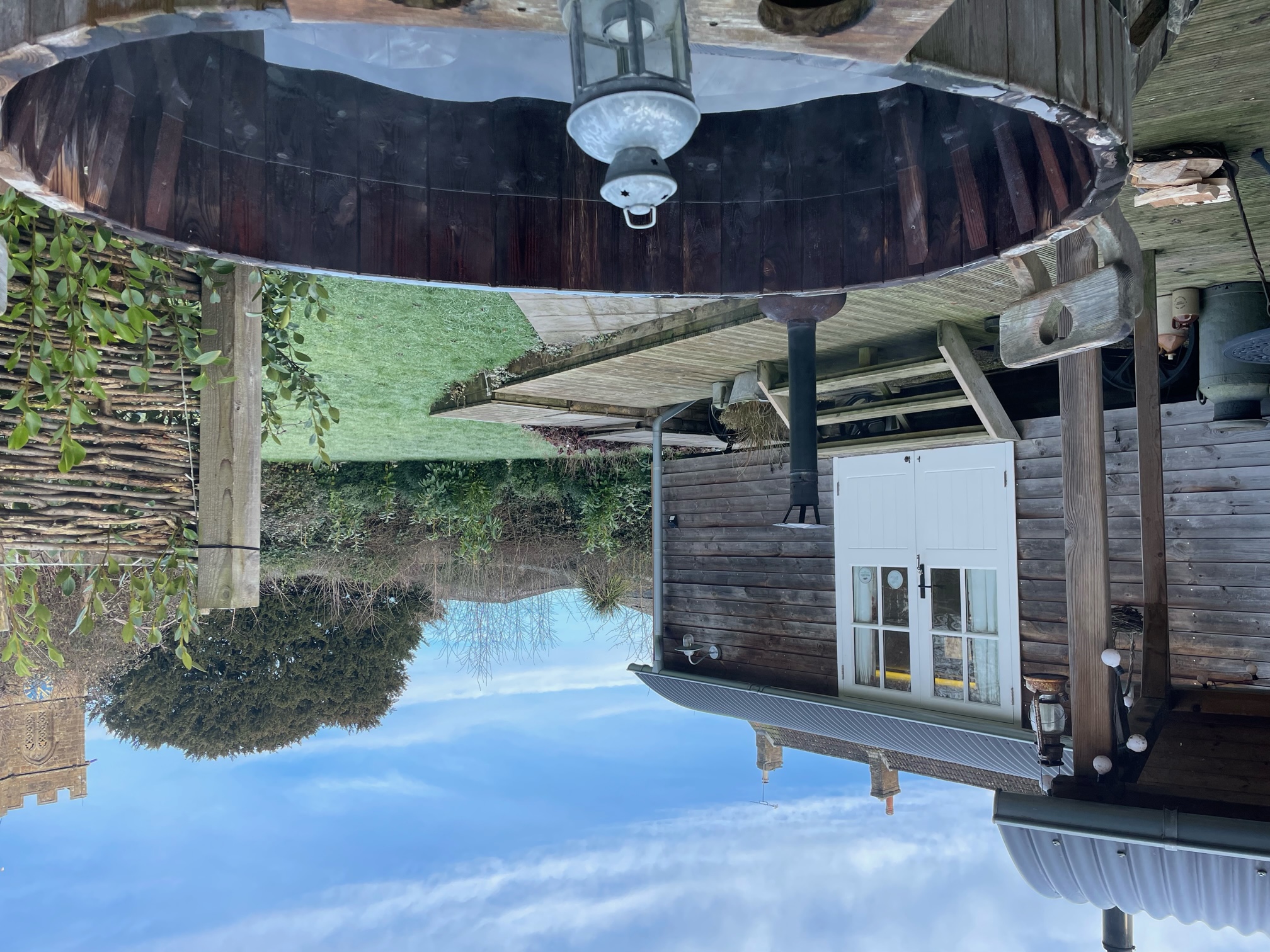 Exterior of a shepherds hut with wood fired hot tub