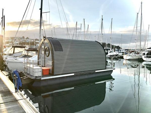 Floating glamping pod docked in a marina
