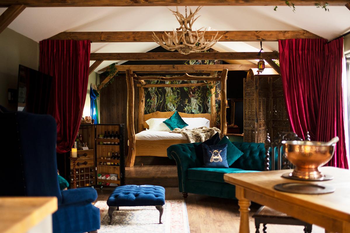 Open plan interior of the lodge with 4 poster bed