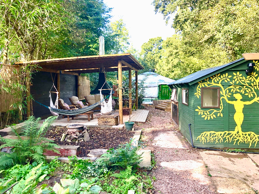 Outside space at Weaver's Yurt, with hammocks and a nice garden